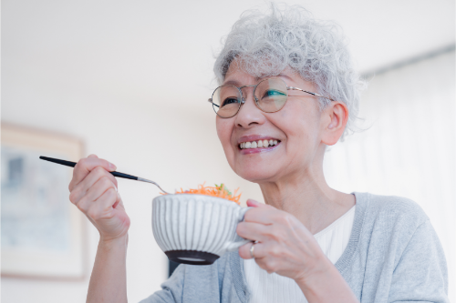 笑顔で食事をする高齢女性